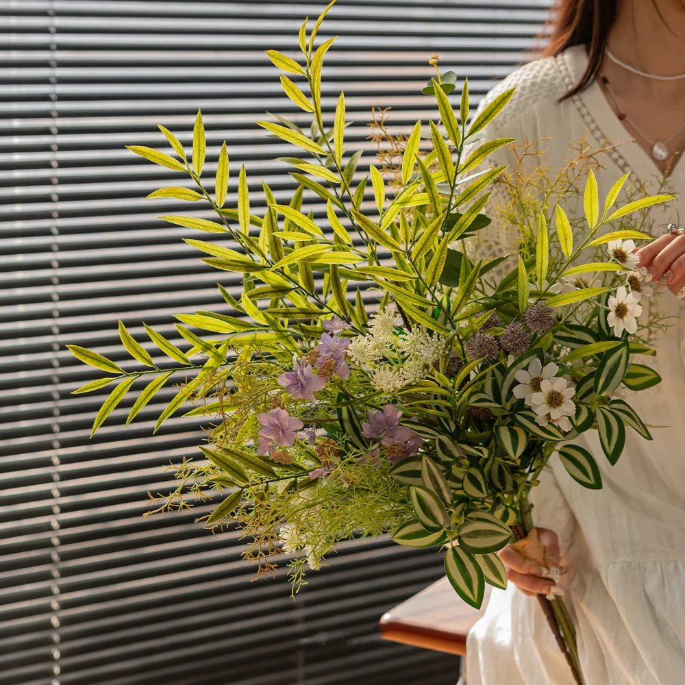 Lime and lilac artificial greenery bunch of mixed ferns, eucalyptus and berry stems, styled in a room setting