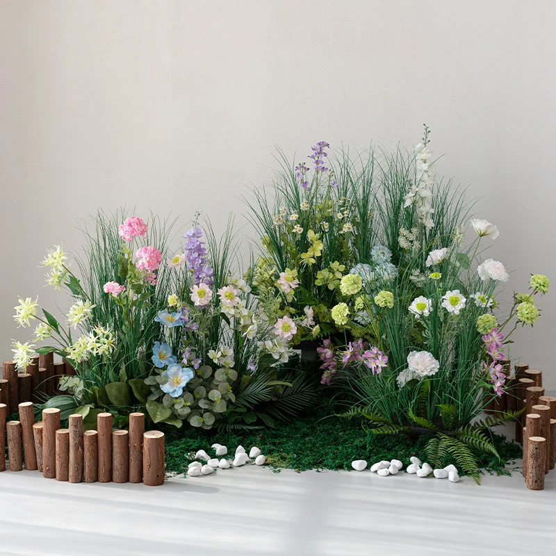 Blush artificial ornamental grass border on a bark and moss base, styled in a room setting