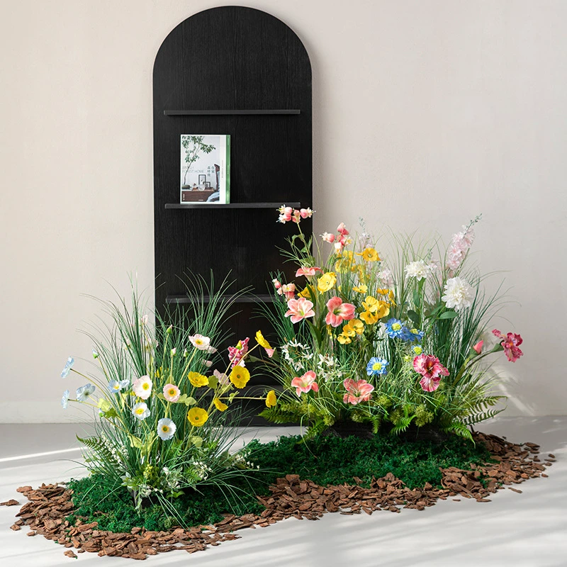 Artificial ornamental grass border on a bark and moss base, styled in a room setting