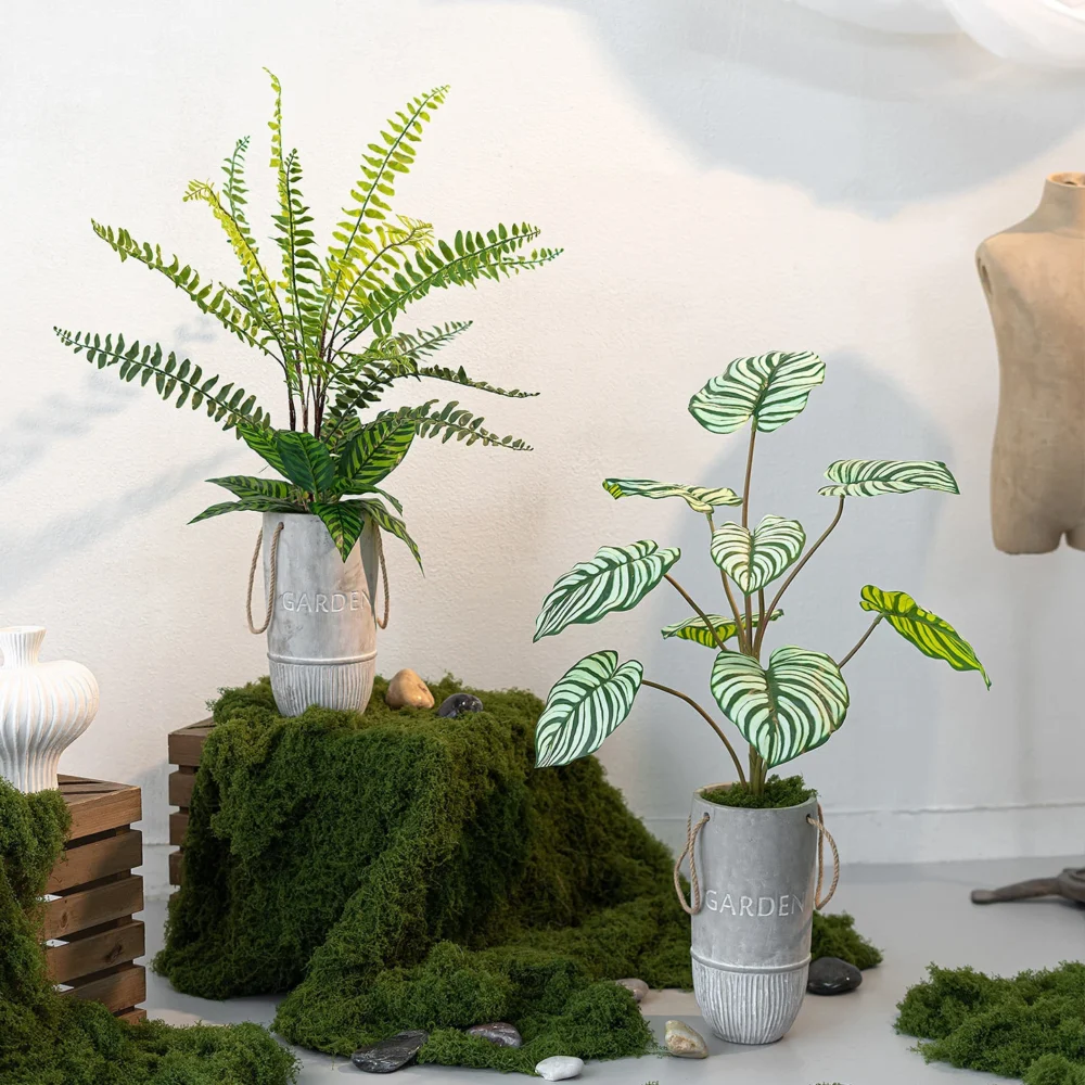 Fern and caladium pair artificial potted plant in a cement pot in a grey cement pot with rope handles, styled in a room setting