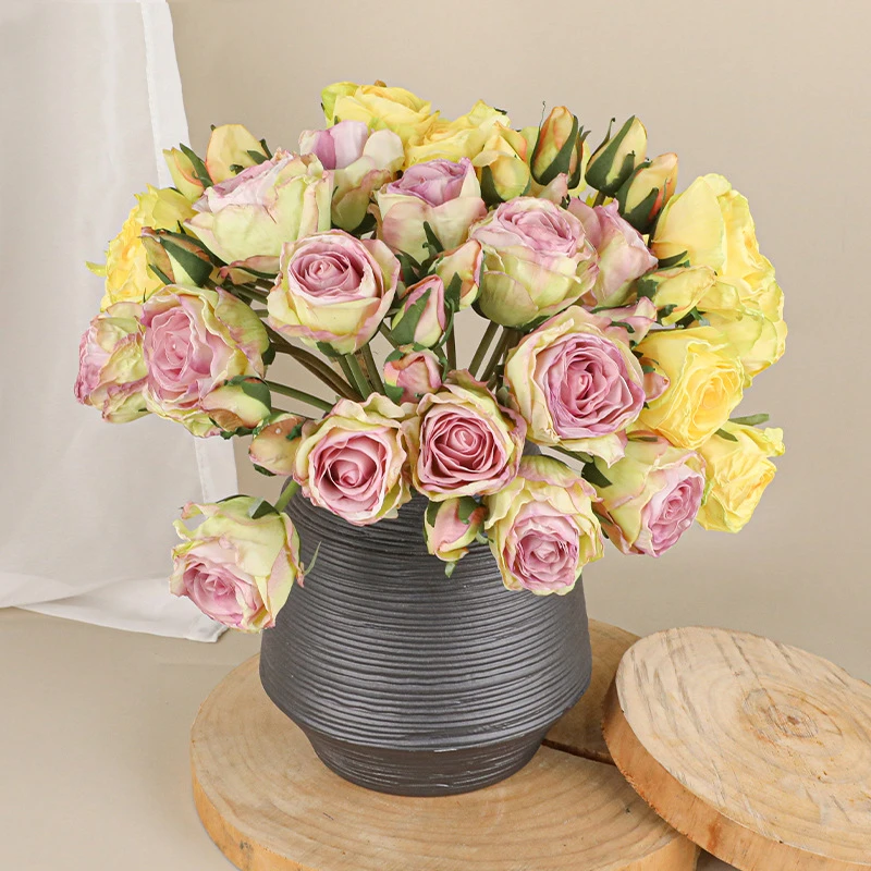 Lilac, in a grey jug artificial rose posy of twelve roses tied at the stem with raffia, arranged in a vase