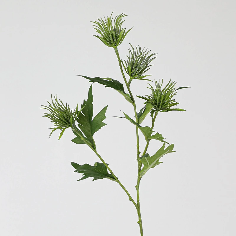 Three heads artificial thistle flower stem with soft lilac crowns sitting above jagged leaves