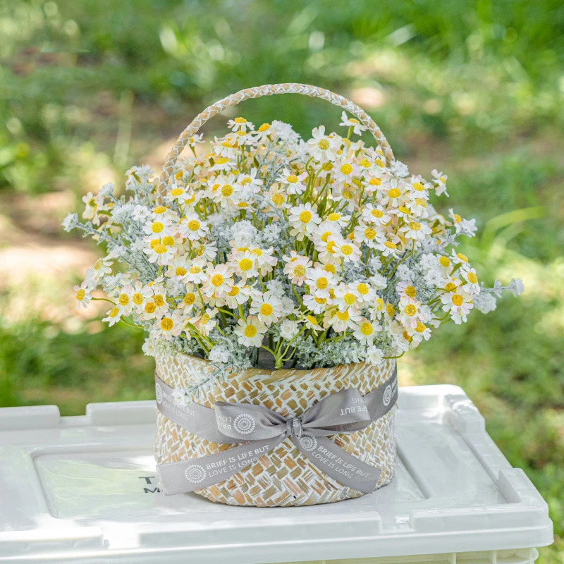 Cream daisy artificial daisy basket massed in a woven cane basket, styled on a table top