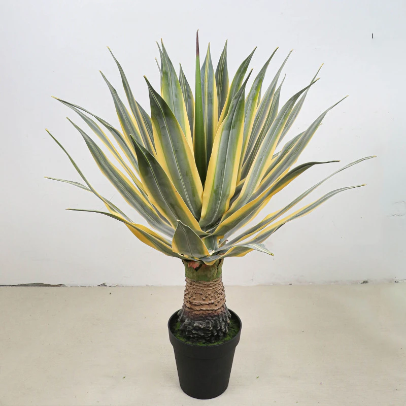Yellow edged on a trunk potted artificial agave finished in a plain black grower's pot