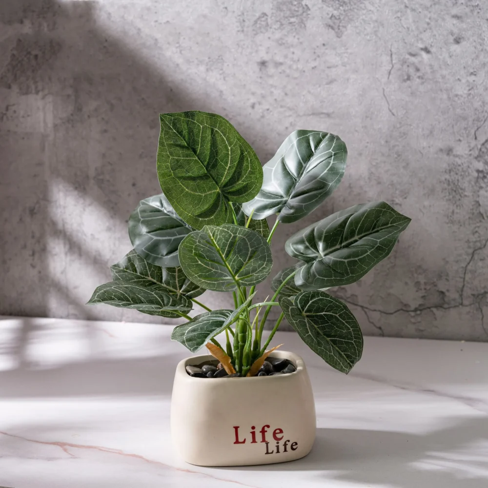 Dark ribbed leaf, in a printed pot small potted artificial plant finished in a glazed ceramic pot