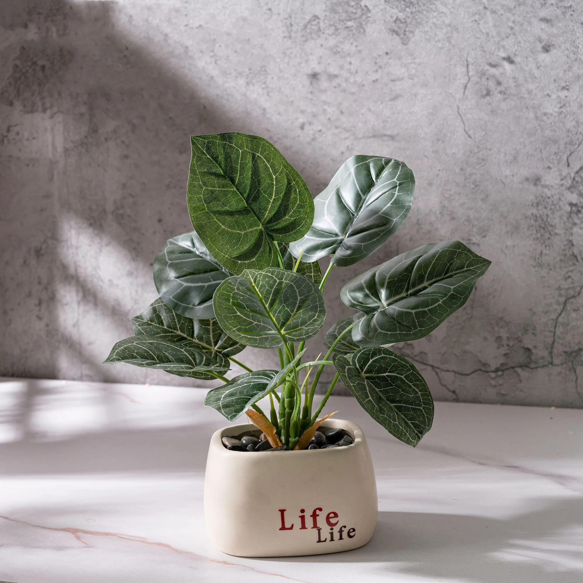 Dark ribbed leaf, in a printed pot small potted artificial plant finished in a glazed ceramic pot